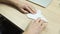 Hand of a man folding a sheet of paper to make a plane. Stock footage. Concept of creative activities, close up of male