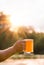 Hand man holding a glass of unfiltered light beer