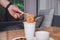 Hand of a man holding a plastic fork with cooked instant noodles. A cup of instant noodle with fork ready to eat convenient and