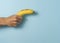 Hand a man holds banana with a copy space