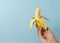 Hand a man holds banana with a copy space