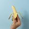 Hand a man holds banana with a copy space