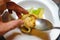 Hand of a man plating ceviche in a restaurant