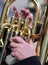 hand of man plays the trombone in the brass band