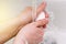 Hand of a man with soap under the tap with water close-up. Hygiene rules and prevention of coronavirus. Hand washing from dirt and