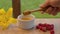 Hand of a man taking honey with honey spoon