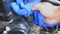 Hand of man using blue micro fiber fabric to clean car