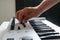 Hand manipulating levels of a musical keyboard. Black and white musical keyboard.