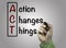 Hand with marker writing Action Changes Things (ACT), business c