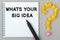 Hand with marker writing: Whats Your Big Idea
