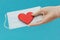 A hand in a medical glove extends a mask with a red heart. Concept - concern for the safety of others, Valentine`s Day, horizonta