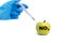 A hand in a medical glove inserts a syringe into a green apple with an inscription NO3 on a white background. Harmful food