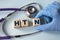 A hand in a medical glove puts cubes with the abbreviation HTN on the background of a stethoscope