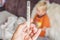 Hand with mercury thermometer and high fever. Little blond boy have a cold and high temperatur and lying. Stay home coronavirus
