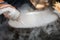 Hand Mixes Liquid Nitrogen In Bowl To Make Frozen Treat