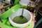 Hand are mixing Cendol with coconut milk , Indonesia desserts called Cendol