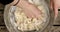 Hand mixing dough in a bowl