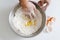 Hand mixing egg yolk,sugar and flour in a bowl