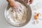 Hand mixing yeast,egg yolk,sugar and flour