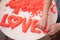 Hand molded of red kinetic sand the word love