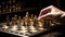 Hand moving strategic chess on golden chess board for business concept.