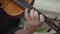 Hand of musician playing arpeggios on violin FDV