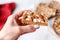 hand with napkin holding an almond butter toast slice