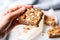 hand with napkin holding an almond butter toast slice