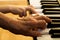 Hand of old piano player and child