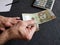 hand of an older man holding a peruvian banknote