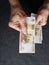 hand of an older man holding a russian banknote