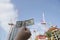 Hand with one hundred american dollars banknotes on the background of a cranes and building construction. Construction industry.