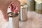 Hand open canned food in metal can on wooden background Close up canned goods non perishable food storage goods in kitchen home