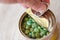 Hand open canned food in metal can on wooden background - Close up  peas canned goods non perishable food storage goods in kitchen