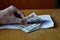 Hand opening an envelope full of Russian currency Russian Ruble, RUB as a symbol of money laundering or bribery in Russia