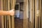 A hand opening a fly stopping door curtain