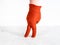 Hand in orange felted glove shows walking woman