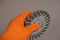 The hand in the orange glove holds the Disc Wire Brush. A tool for woodworking as well as stripping surfaces of corrosion, scale,