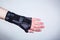 Hand in orthopedic orthosis on white backgroud