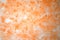 Hand painted abstract ice watercolor texture in monochrome orange as background for copy space