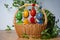 Hand painted Easter eggs, made of wood in a brown wicker basket â€“ decoration of a holiday table during celebration