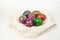 Hand-painted Easter eggs on a white embroidered napkin