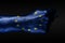 A hand with a painted EU flag shows a fig, a sign of aggression, disagreement, a dispute on a dark background