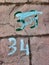 Hand Painted House Number 34 on Old Building