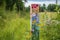 hand-painted trail marker pointing the way through wildflower meadow
