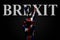 On a hand with a painted UK flag and the word BREXIT, on a dark background is a peace sign, a symbol of peace, friendship,