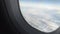 Hand of passenger opening window shade before landing, flight safety measures