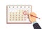 Hand with pen marks date in calendar. Deadline and important events vector concept