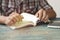 Hand of people, student opening and reading text book on wood table with copy space, in library, concept as education attempt and