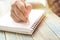 Hand of people, student writing and note on notebook on wood table with copy space, in library, concept as education attempt and m